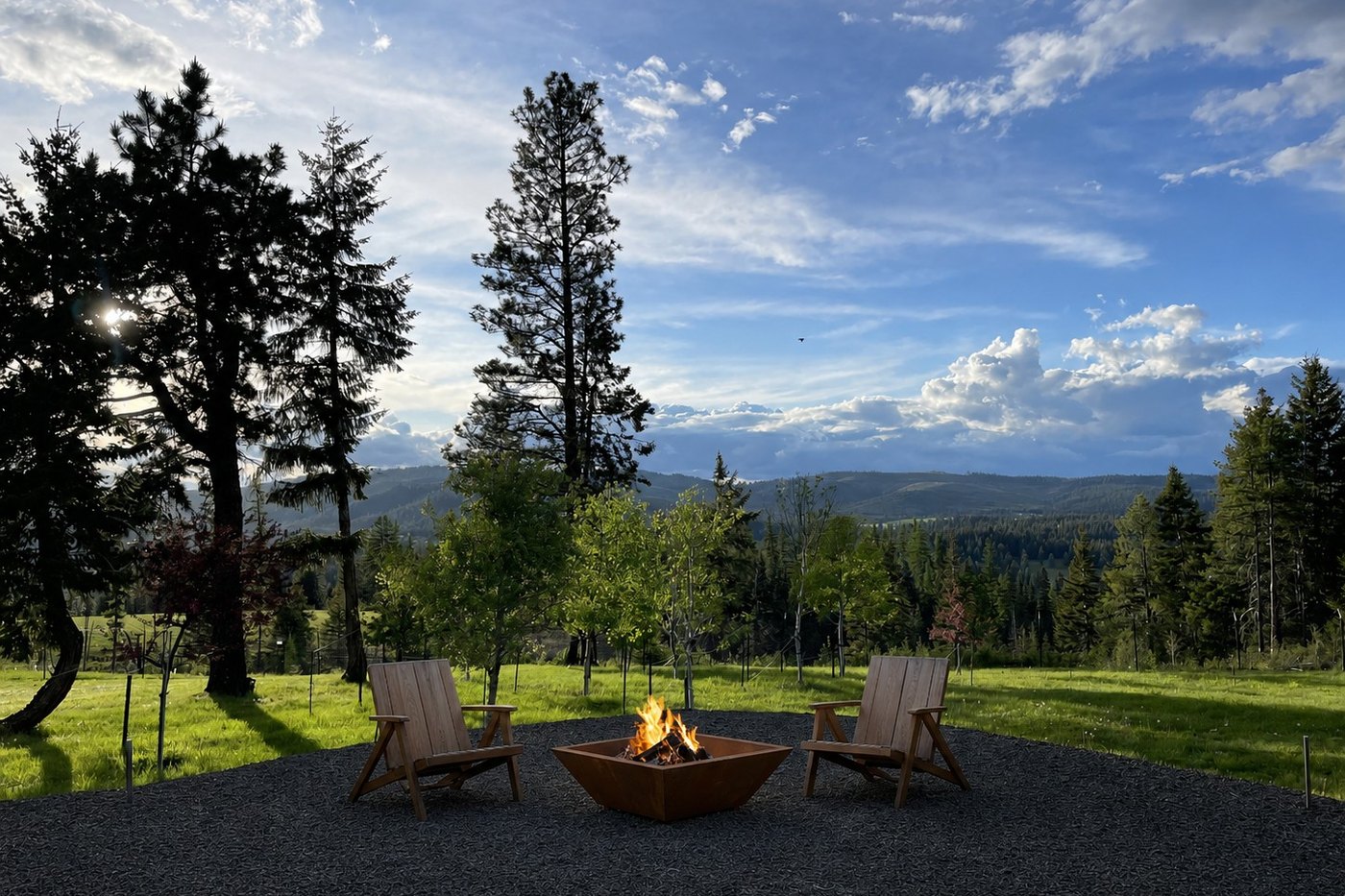 Summer evening at the backyard fire pit, looking west